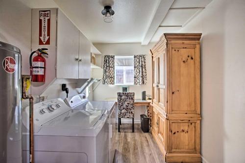 a kitchen with a white washer and a wooden cabinet at S Cottonwood Home with Yard, 3 Mi to Main St in Cottonwood