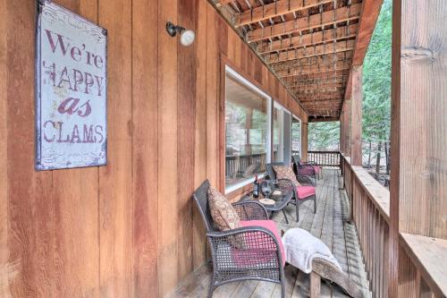 a porch with chairs and a table on a building at Walk to Big Trees State Park Cabin with Deck! in Dorrington