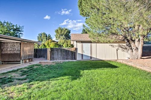 a yard with a fence and a house at S Cottonwood Home with Yard, 3 Mi to Main St in Cottonwood