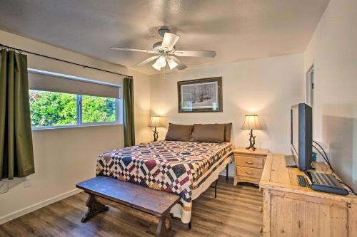 a bedroom with a bed and a flat screen tv at S Cottonwood Home with Yard, 3 Mi to Main St in Cottonwood