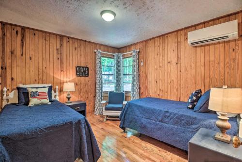a bedroom with two beds and a chair in it at Waterfront Lake Martin Home with Grill and Beach! in Eclectic