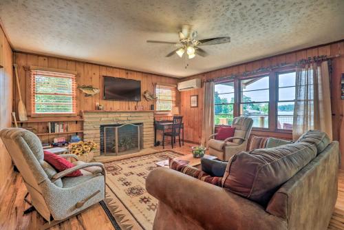a living room with two couches and a fireplace at Waterfront Lake Martin Home with Grill and Beach! in Eclectic