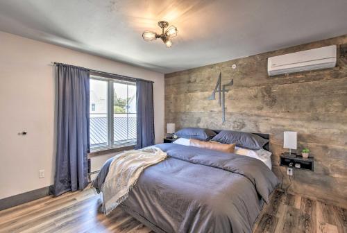 a bedroom with a large bed and a cross on the wall at Modern Townhome with Deck - half Mi to Elkhart Lake! in Elkhart Lake