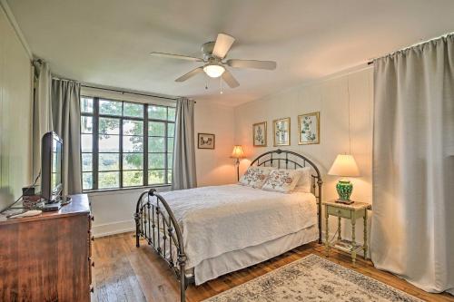 a bedroom with a bed and a ceiling fan at Charming Summerville Home with Yard and Sunroom! in Summerville