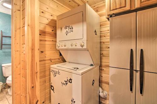 a kitchen with a refrigerator and a washer and dryer at Rustic Gatlinburg Chalet with Hot Tub 2 Mi to Town in Gatlinburg