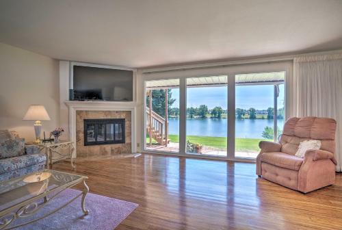 a living room with a couch and a chair and a fireplace at Lake House with Hot Tub - 1 Mi to Surf n Slide in Moses Lake
