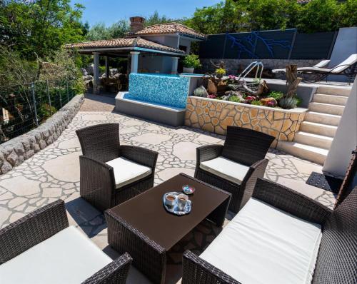 a patio with two chairs and a table with a table at Apartment Roko in Županje