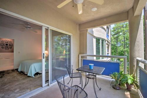 a balcony with a table and chairs and a bedroom at Condo on Lake Keowee with Resort Amenities and Pool! in Salem