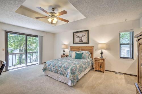 a bedroom with a bed and a ceiling fan at Lake of the Ozarks Home with Game Room, BBQ and Dock! in Osage Beach