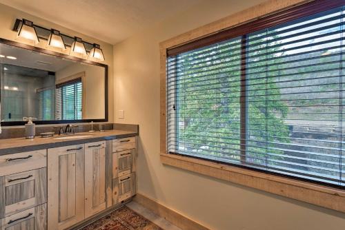 a bathroom with a large window and a large sink at Renovated Historic Cabin about 25 Miles to Park City! in Samak