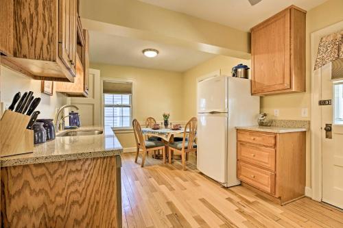 a kitchen with a white refrigerator and a table at Lexington Getaway with Backyard Deck Less Than 2 Mi to UK! in Lexington