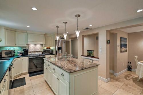 een grote keuken met witte kasten en een groot eiland bij Cape Cod Area Home with Fire Pit Less Than 4 Mi to Beach! in East Falmouth