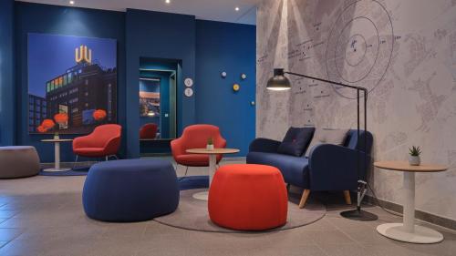 a lobby with chairs and a couch and tables at Holiday Inn Express Dortmund by IHG in Dortmund