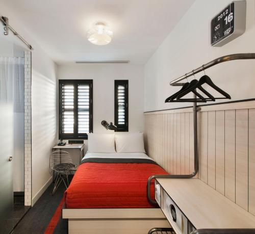 a bedroom with a bed with a red blanket at Pod 39 in New York