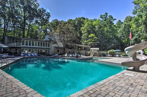 a swimming pool in front of a house at Eclectic Cabin with Hot Tub 1 Mi to Ober Gatlinburg in Gatlinburg
