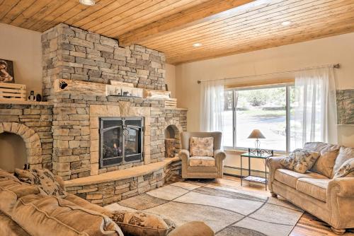 a living room with a large stone fireplace at Casa Immaculata on Chalk Creek with Views! in Nathrop