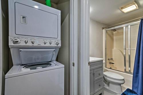 a small bathroom with a toilet and a washing machine at Mount Ida Condo - Walk to Lake Ouachita! in Mount Ida
