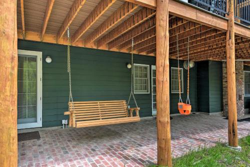 a porch swing hanging from a green house at Casa Immaculata on Chalk Creek with Views! in Nathrop
