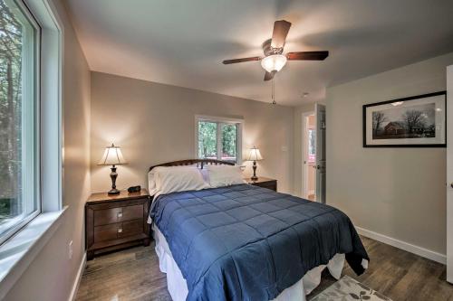 a bedroom with a bed and a ceiling fan at Hike, Hunt and Unwind Cozy Cabin Near Hersheypark in Jonestown