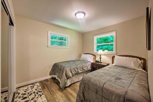 a bedroom with two beds and two windows at Hike, Hunt and Unwind Cozy Cabin Near Hersheypark in Jonestown