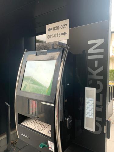 an atm machine with a screen in a building at Blackhome Innsbruck City East I contactless check-in in Innsbruck
