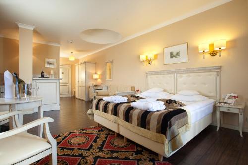 a bedroom with a large bed with pillows on it at Hotel Royal Baltic 4* Luxury Boutique in Ustka