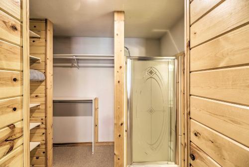 ducha a ras de suelo en un armario con paredes de madera en 40-Acre Trego Resort Cabin with Lake and Trails!, en Trego