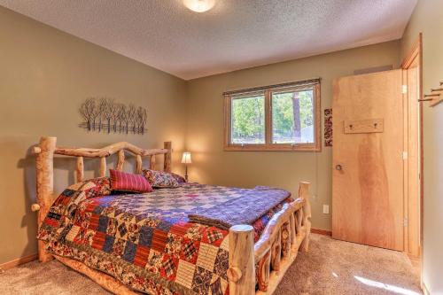 a bedroom with a bed and a window at Lead Cabin about 9 Mi to Deadwood Hot Tub and Patio! in Lead