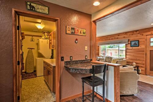 a kitchen with a counter with a chair in a room at Gold Beach Apartment with Activities - 2 Mi to Ocean in Gold Beach