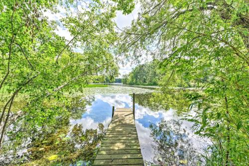 a wooden dock in the middle of a lake at Fishermens Paradise with Fire Pit on Rice Lake! in Rice Lake
