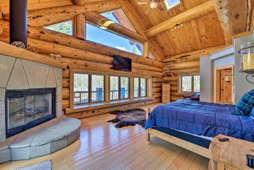 a log cabin bedroom with a bed and a fireplace at 22STR-00019 Fairplay Cabin with Hot Tub and Sauna in Fairplay