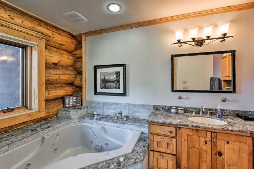 a bathroom with a tub and a sink and a mirror at 22STR-00019 Fairplay Cabin with Hot Tub and Sauna in Fairplay