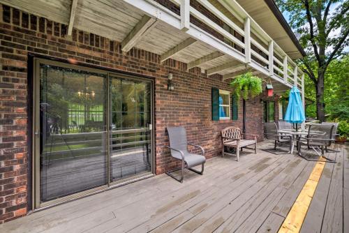 a patio with chairs and a table on a brick building at Waterfront Lake Barkley Home with Deck and Fire Pit! in Cadiz