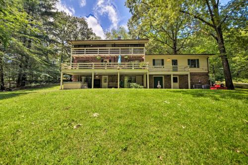 a house on a hill with a large yard at Waterfront Lake Barkley Home with Deck and Fire Pit! in Cadiz