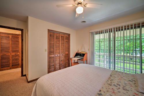 a bedroom with a bed and a large window at Waterfront Lake Barkley Home with Deck and Fire Pit! in Cadiz