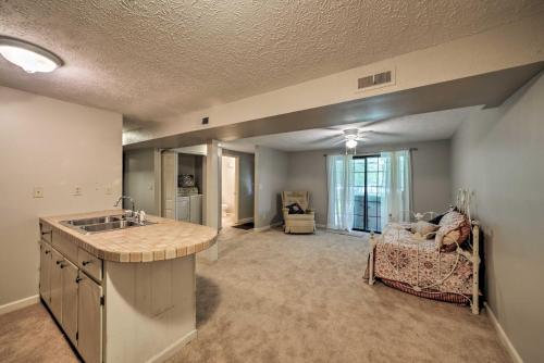 a kitchen with a sink and a living room at Waterfront Lake Barkley Home with Deck and Fire Pit! in Cadiz