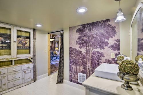 a bathroom with a large painting on the wall at Historic Winston-Salem Guest Barn on Farm! in Winston-Salem