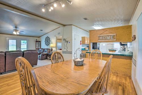 a dining room with a wooden table and chairs at Cedar Creek Lake Access Retreat with Deck in Kemp