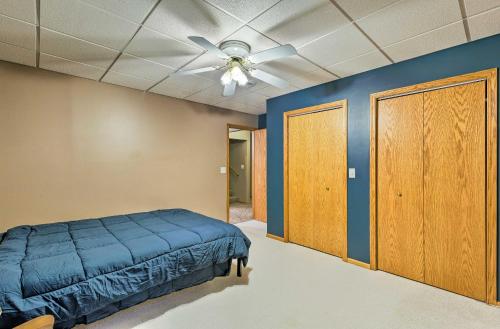 a bedroom with a bed and a ceiling fan at Elwood Townhome with Patio - 7 Mi to Johnson Lake in Elwood
