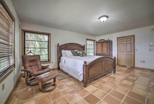 a bedroom with a bed and a chair in it at Welaka House with Private Dock on St Johns River in Georgetown
