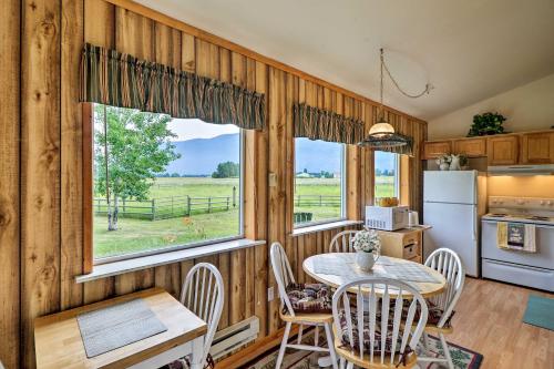 a kitchen and dining room with a table and a window at Columbia Falls Home 19 Mi to Glacier National Park in Columbia Falls