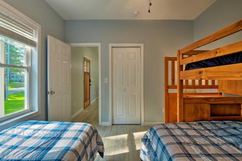 a bedroom with a bunk bed and a window at Covered Deck, Grill and Game Room Gilford House! in Gilford