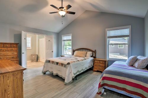 a bedroom with a bed and a ceiling fan at Covered Deck, Grill and Game Room Gilford House! in Gilford