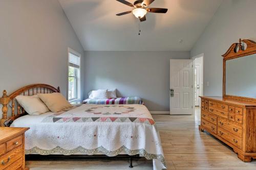 a bedroom with a bed and a ceiling fan at Covered Deck, Grill and Game Room Gilford House! in Gilford