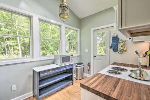a kitchen with a stove and some windows at Ephraim Home with Yard - Walk to Lake Michigan! in Ephraim