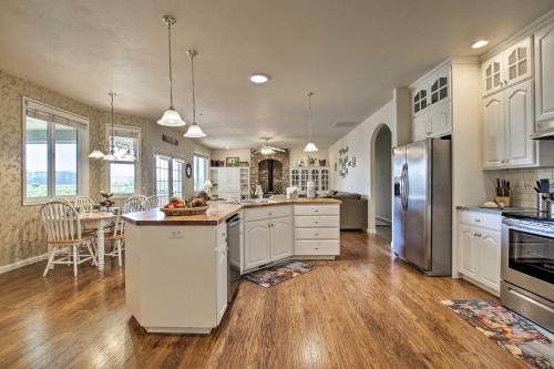 a large kitchen with white cabinets and a kitchen island at McMinnville Wine Country Home with Hot Tub and Deck in McMinnville
