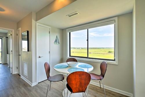 a dining room with a table and chairs and a window at Carolina Beach Home with Views and Pool Access! in Carolina Beach