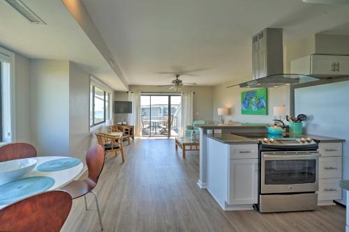 a kitchen and dining room with a table and a stove at Carolina Beach Home with Views and Pool Access! in Carolina Beach
