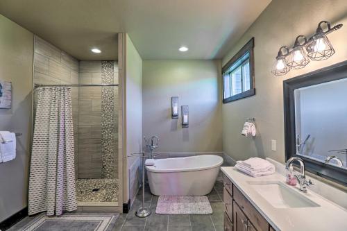 a bathroom with a tub and a sink and a shower at Newly Built Kalispell Home - 28 Mi to Glacier NP! in Kalispell