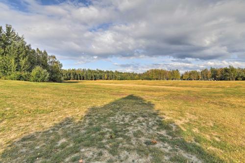 a shadow of a person in a field at Charming Anchorage Home with Grill and Deck! in Anchorage